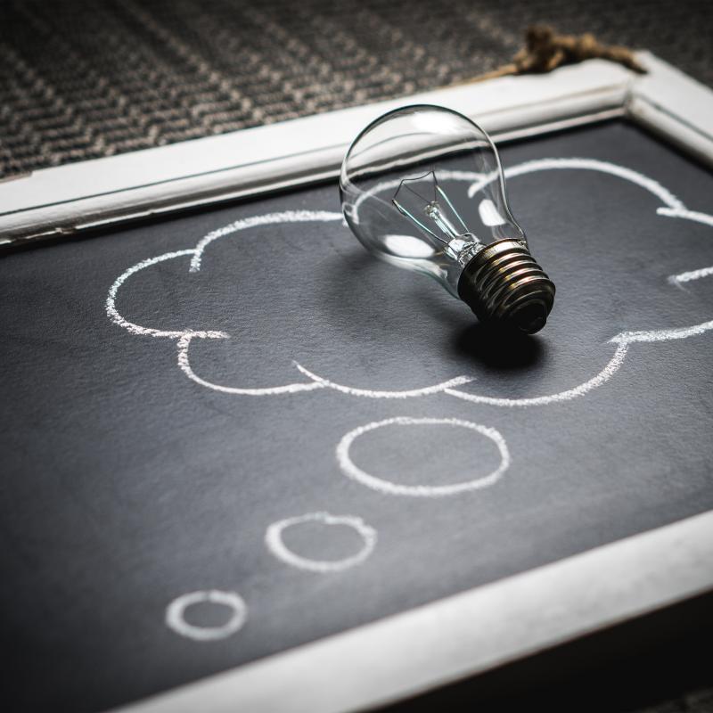 Chalkboard with light bulb representing ideas